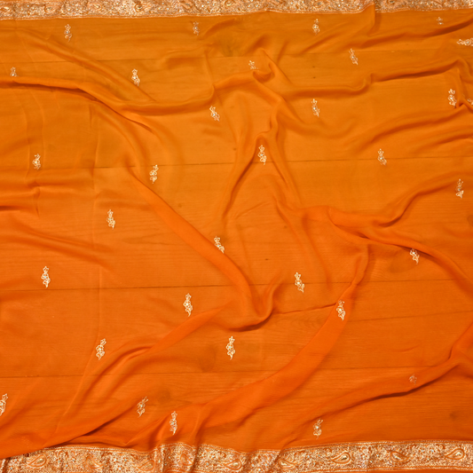 (DELIVERY IN 40 DAYS) VIBRANT MARIGOLD ORANGE PURE PLATINUM CHIFFON SAREE WITH AARI ZARDOZI WORK BORDER