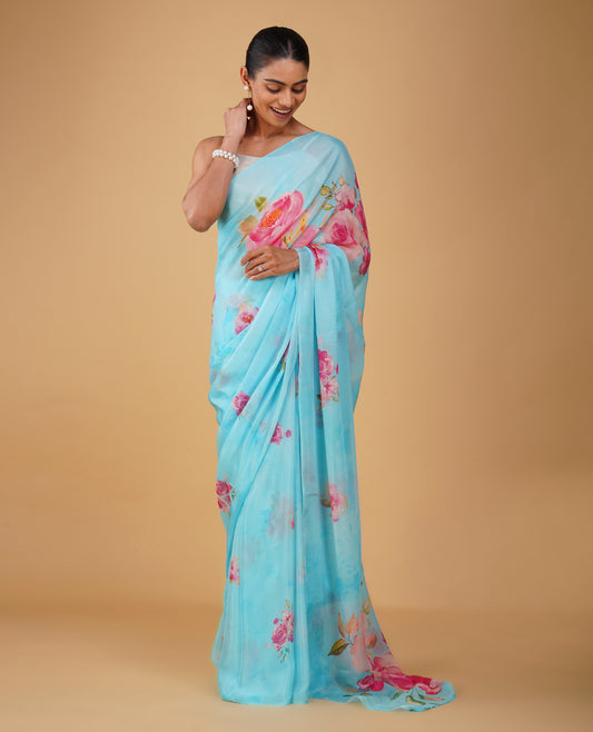 ( DELIVERY IN 15-20 DAYS ) CAPRI BLUE PRINTED CHINON SAREE WITH THIN ZARI WEAVE AND PLAIN CREPE BLOUSE