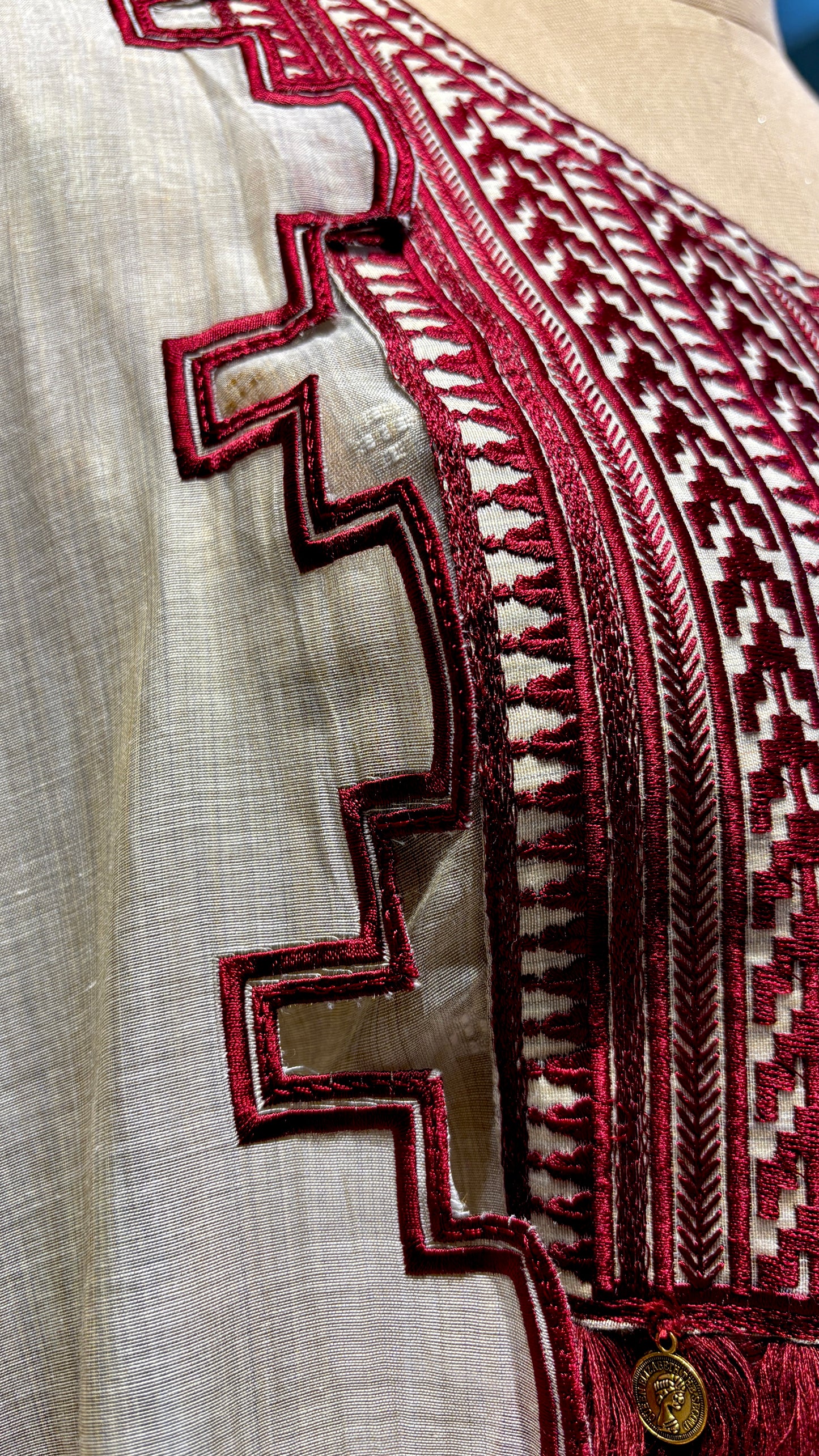 BEIGE JAMDANI DHAKAI COTTON UNSTITCHED SUIT EMBELLISHED WITH RED RESHAM EMBROIDERY, TASSELS ON KURTA & SCALLOP BORDER PRINTED DUPATTA