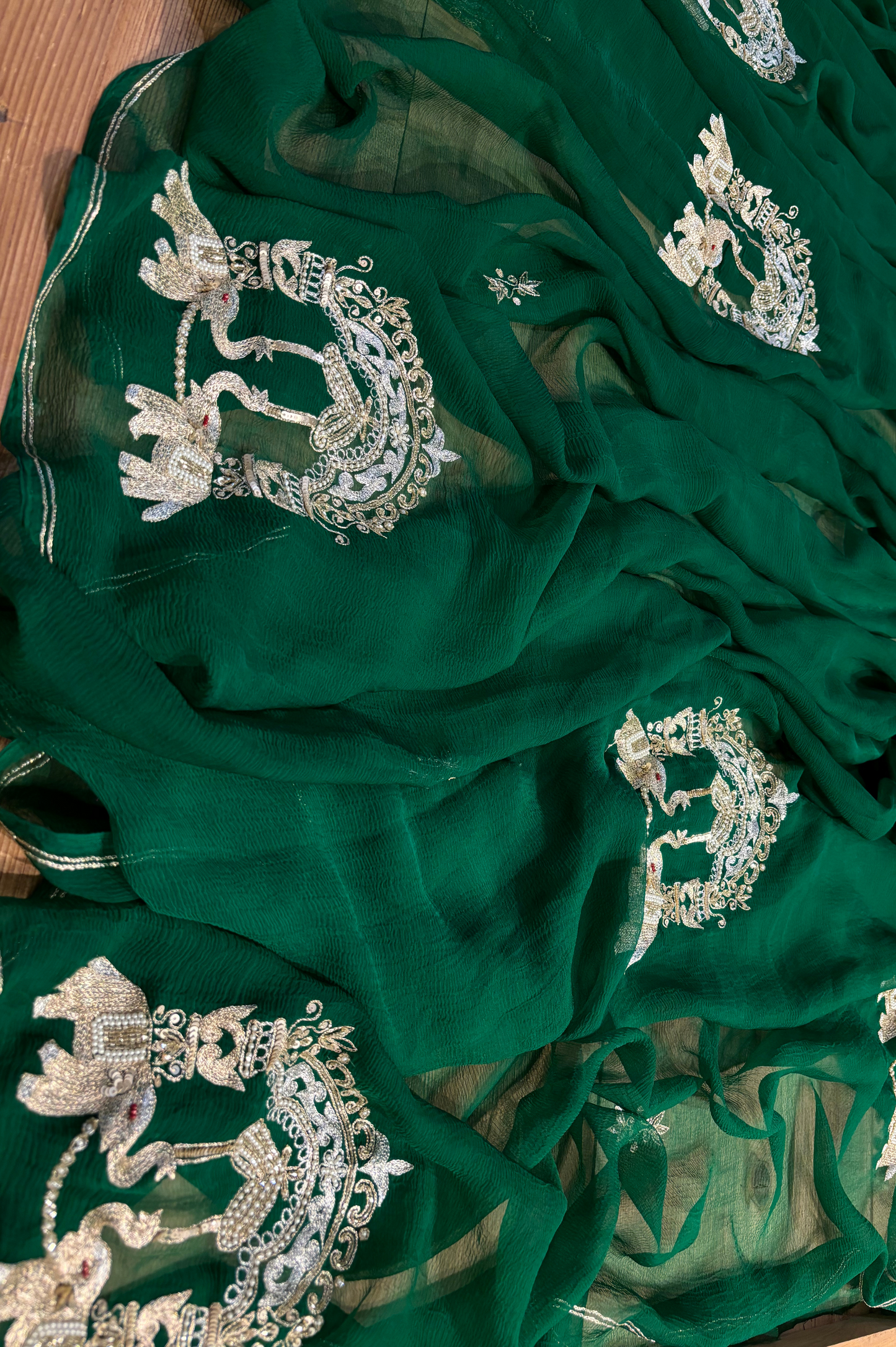 BOTTLE GREEN CHIFFON SAREE WITH INTRICATE AARI ZARDOZI EMBROIDERED ELEPHANT TEMPLE MOTIFS