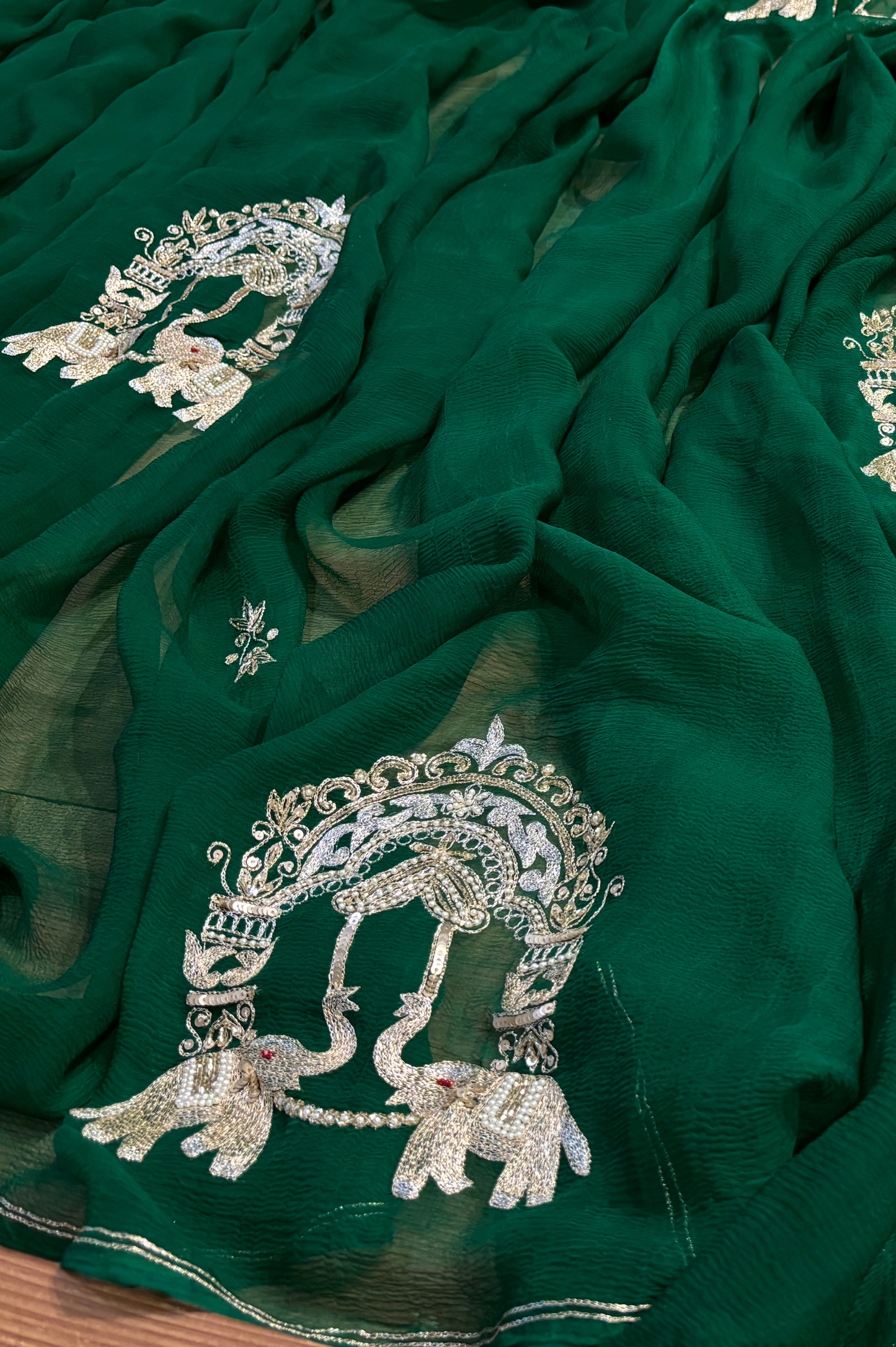 BOTTLE GREEN CHIFFON SAREE WITH INTRICATE AARI ZARDOZI EMBROIDERED ELEPHANT TEMPLE MOTIFS