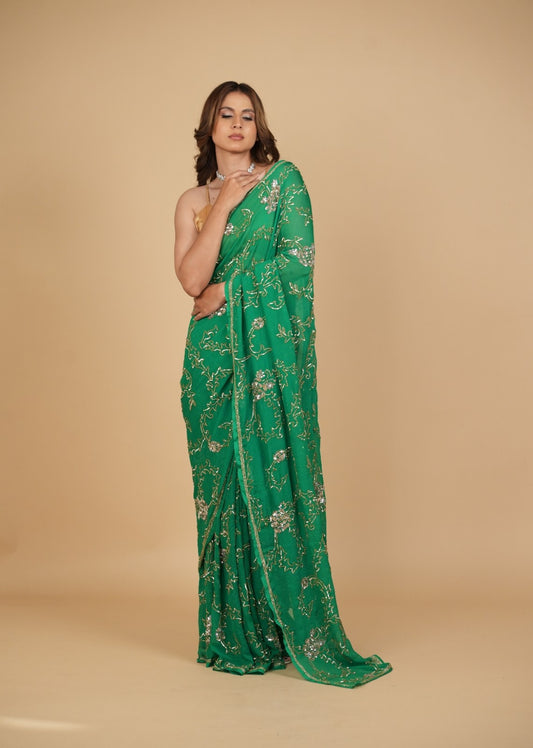 EMERALD GREEN PURE PLATINUM CHIFFON SAREE WITH SEQUINS JAAL HAND EMBROIDERY PAIRED WITH CREPE BLOUSE WITH EMBROIDERED SLEEVES