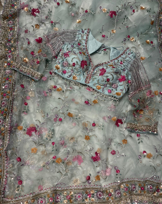 PASTEL BLUE NET SAREE EMBELLISHED WITH SEQUINS & CUTDANA WORK PAIRED WITH A READYMADE BLOUSE
