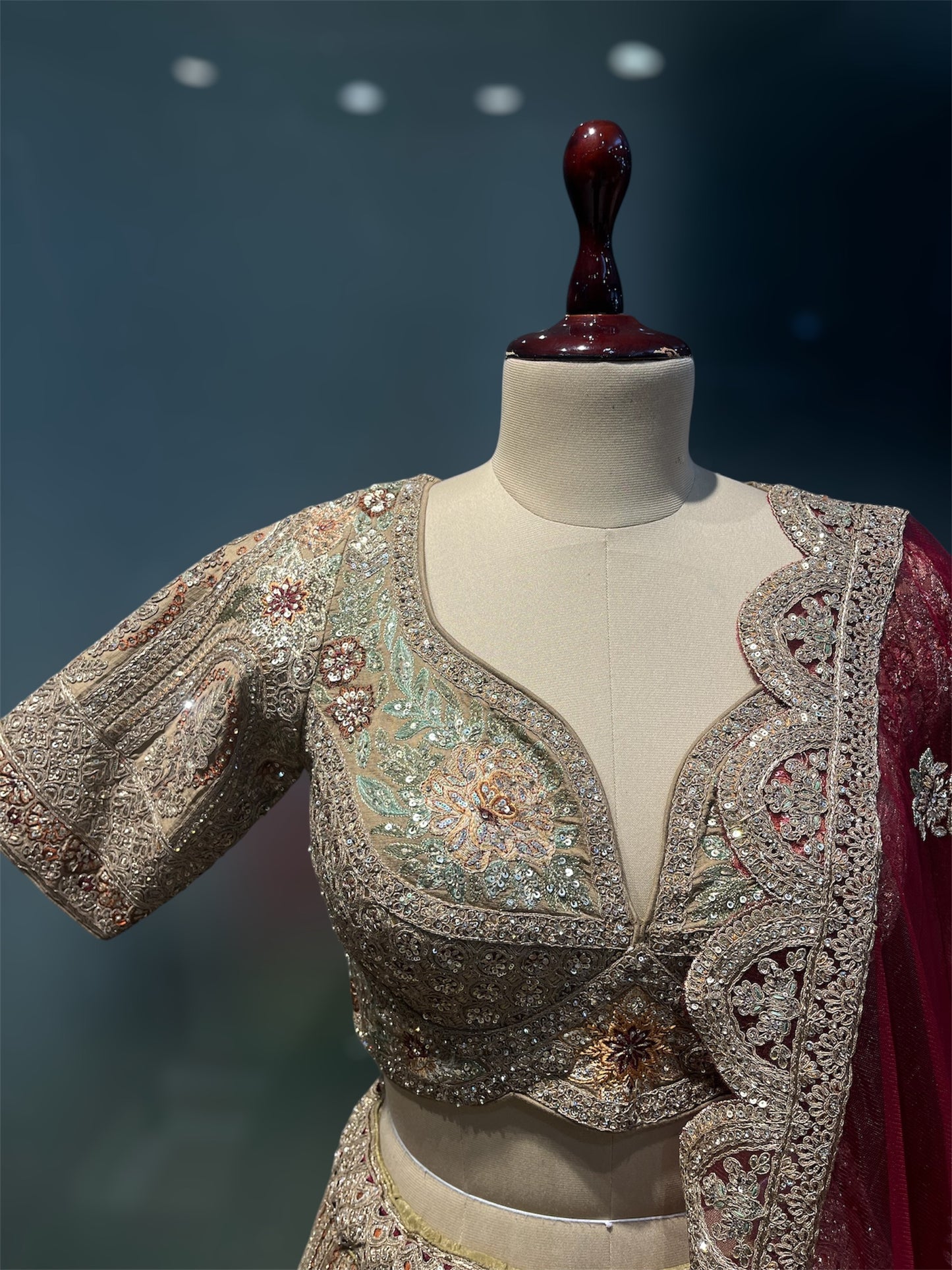 GOLDEN MATTE FINISH ZARI LEHENGA WITH READYMADE BLOUSE AND RED CONTRAST SCALLOPED BORDER DUPATTA, PAIRED WITH AN EXTRA RED DUPATTA