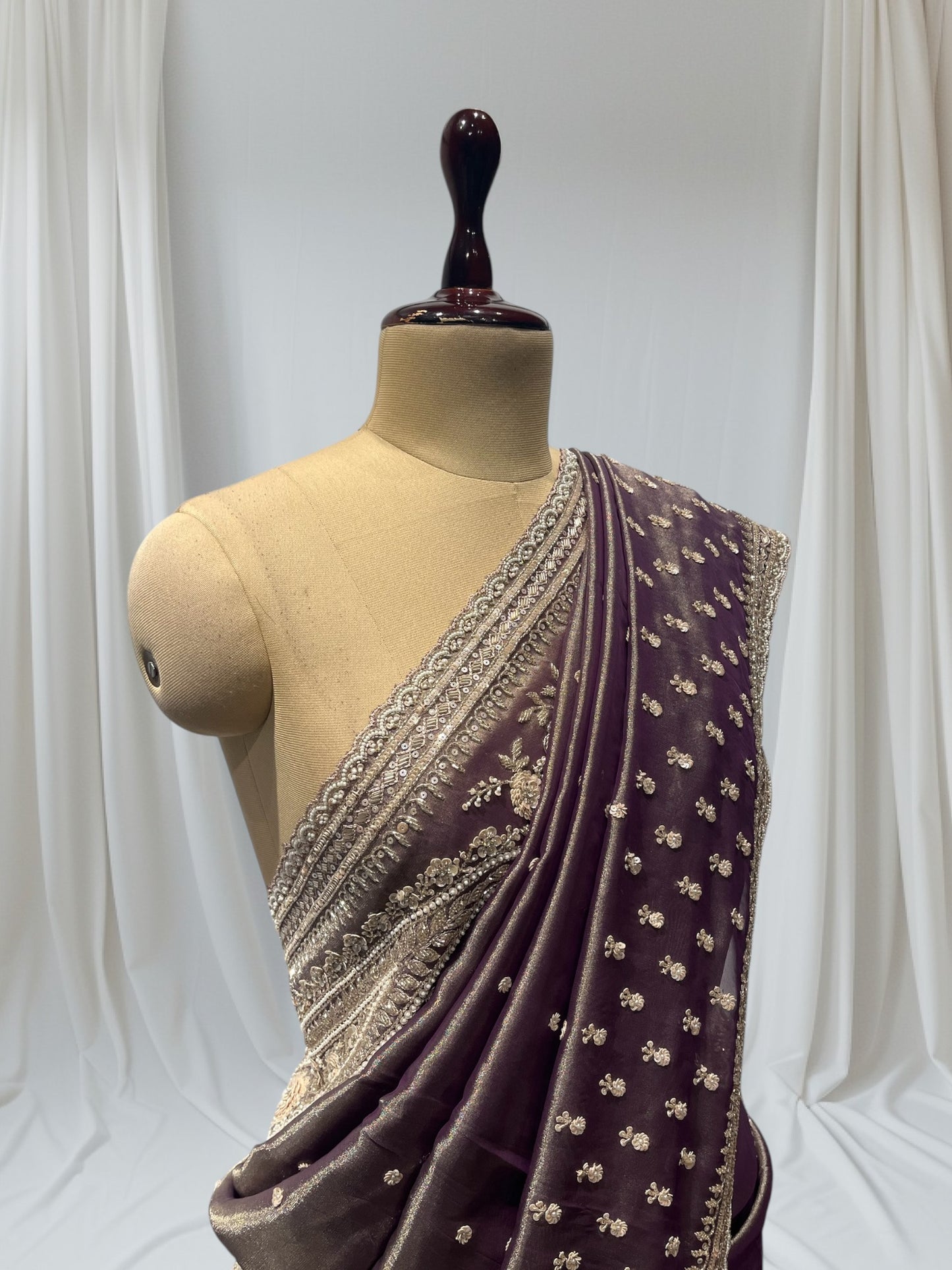 DUSTY WINE COLOR, GEOGETTE TISSUE SAREE WITH SEQUINS, PEARL & CUTDANA EMBROIDERY, PAISLEY MOTIFS ARE PLACED ON SHOULDER AND PALLA.