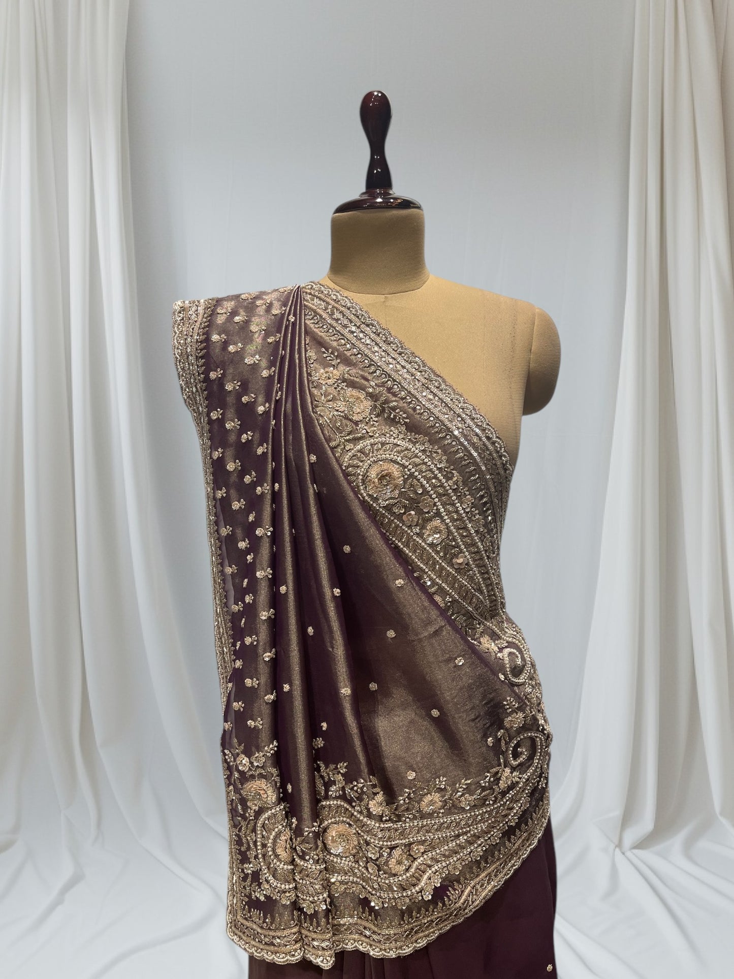 DUSTY WINE COLOR, GEOGETTE TISSUE SAREE WITH SEQUINS, PEARL & CUTDANA EMBROIDERY, PAISLEY MOTIFS ARE PLACED ON SHOULDER AND PALLA.