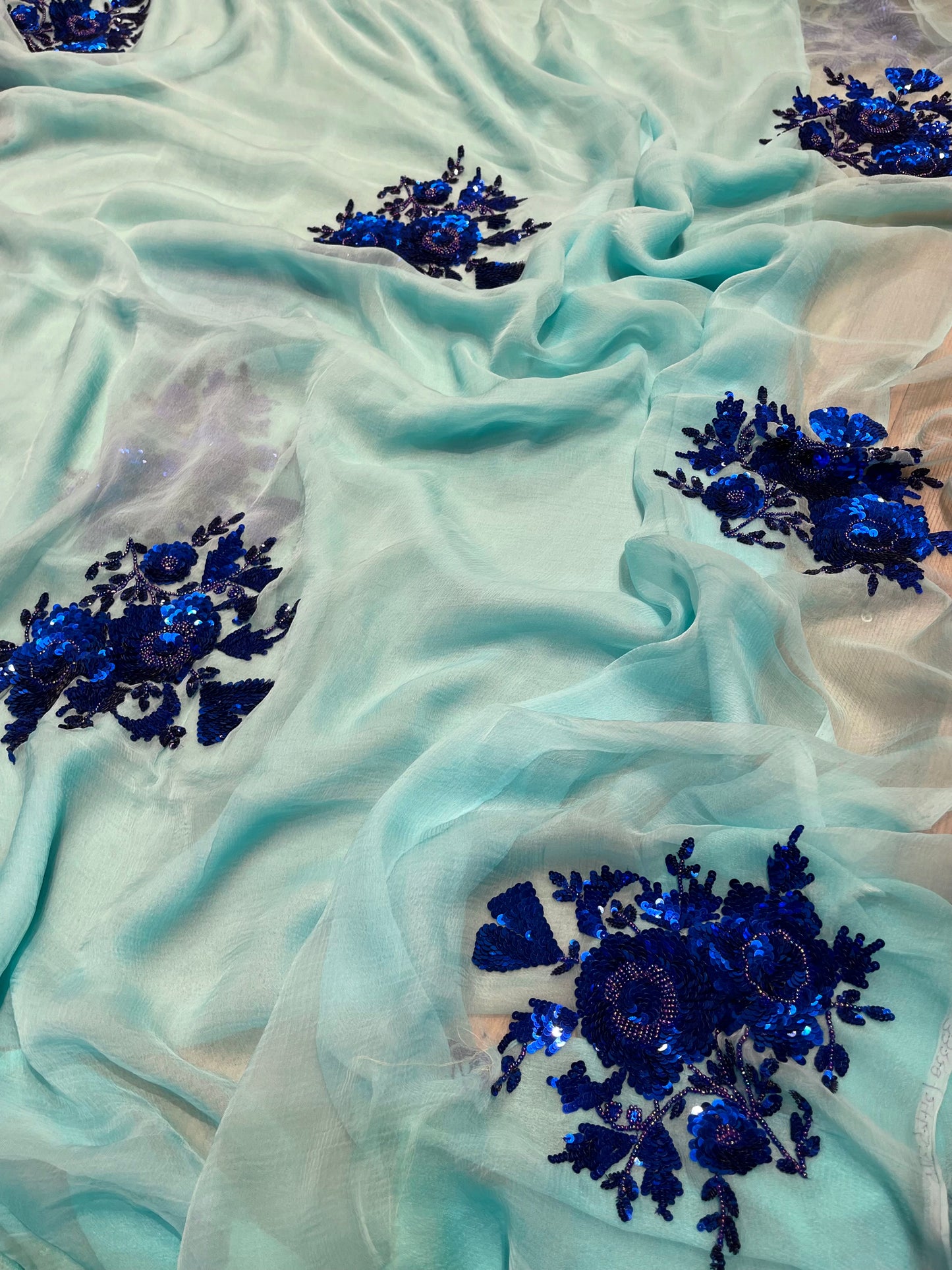 ( DELIVERY IN 20-25 DAYS ) AQUA COLOUR CHIFFON HAND EMBROIDERED SAREE EMBELLISHED WITH SEQUINS WORK