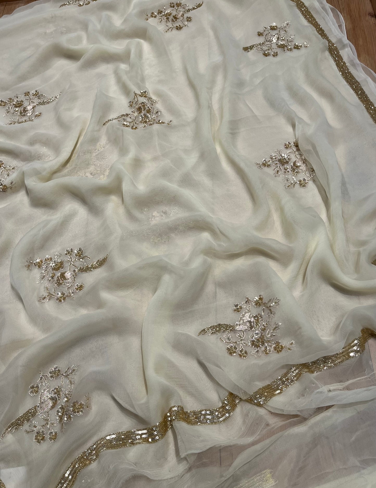 IVORY COLOUR CHIFFON HAND EMBROIDERED SAREE EMBELLISHED WITH CUTDANA, SEQUINS & AARI WORK