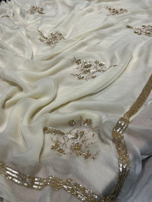 (DELIVERY IN 30 DAYS) IVORY COLOUR CHIFFON HAND EMBROIDERED SAREE EMBELLISHED WITH CUTDANA, SEQUINS & AARI WORK