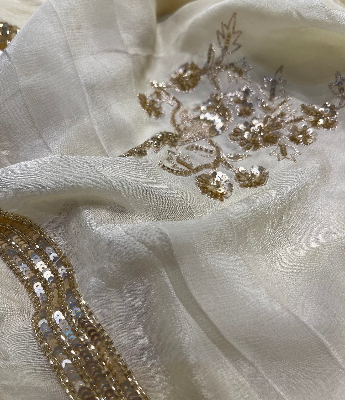 IVORY COLOUR CHIFFON HAND EMBROIDERED SAREE EMBELLISHED WITH CUTDANA, SEQUINS & AARI WORK