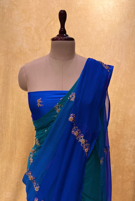 GREEN & BLUE PURE CHIFFON HAND EMBROIDERED SAREE EMBELLISHED WITH ZARDOZI, CUTDANA & AARI WORK - Kothari Sons