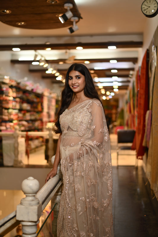 ( DELIVERY IN 25 DAYS ) BEIGE COLOUR NET HAND EMBROIDERED SAREE EMBELLISHED WITH ZARI, SEQUENCE & CUTDANA WORK