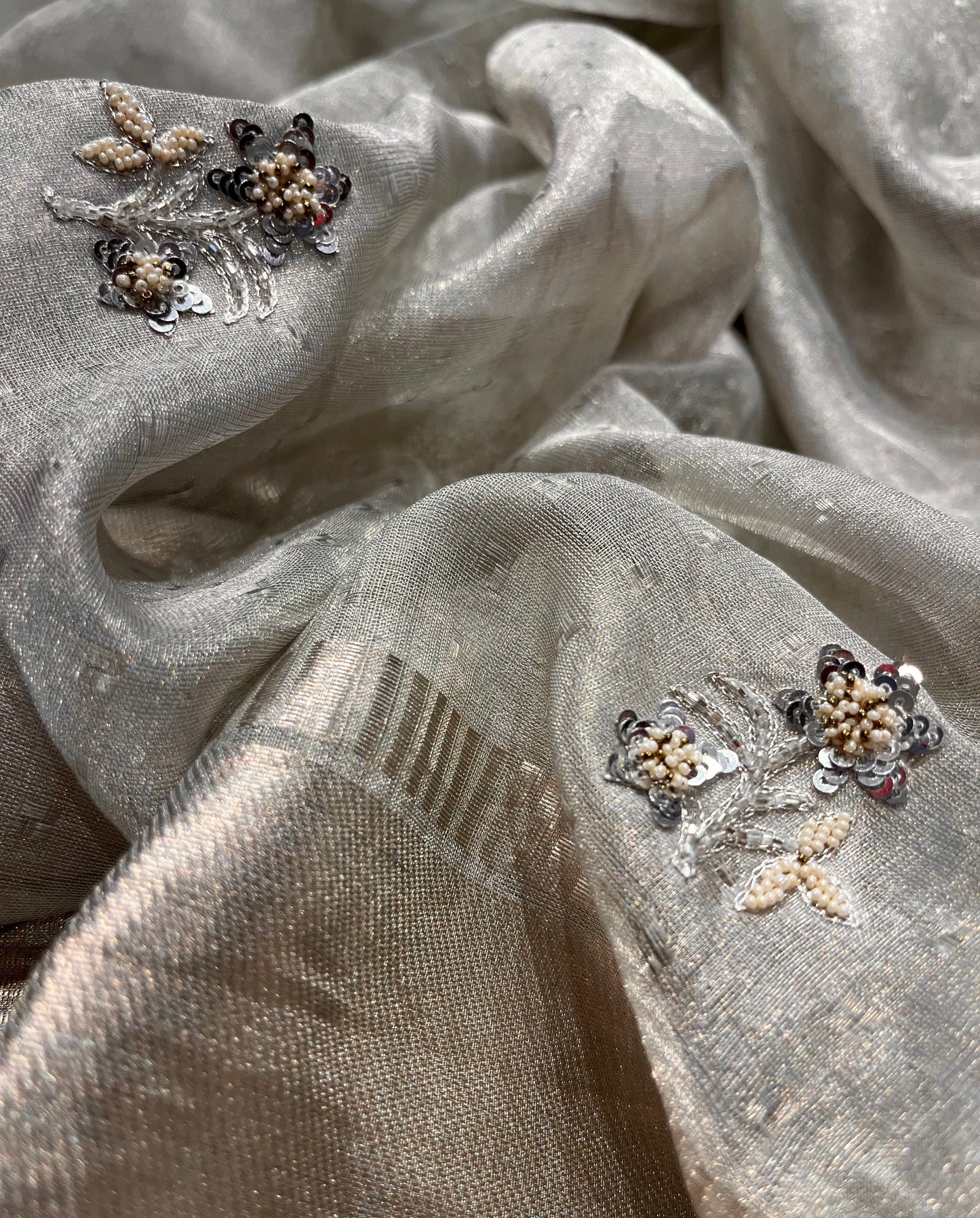 ( DELIVERY IN 25 DAYS ) SILVER COLOUR TISSUE NET HANDLOOM HAND EMBROIDERED SAREE EMBELLISHED WITH SEQUINS & BEADS WORK