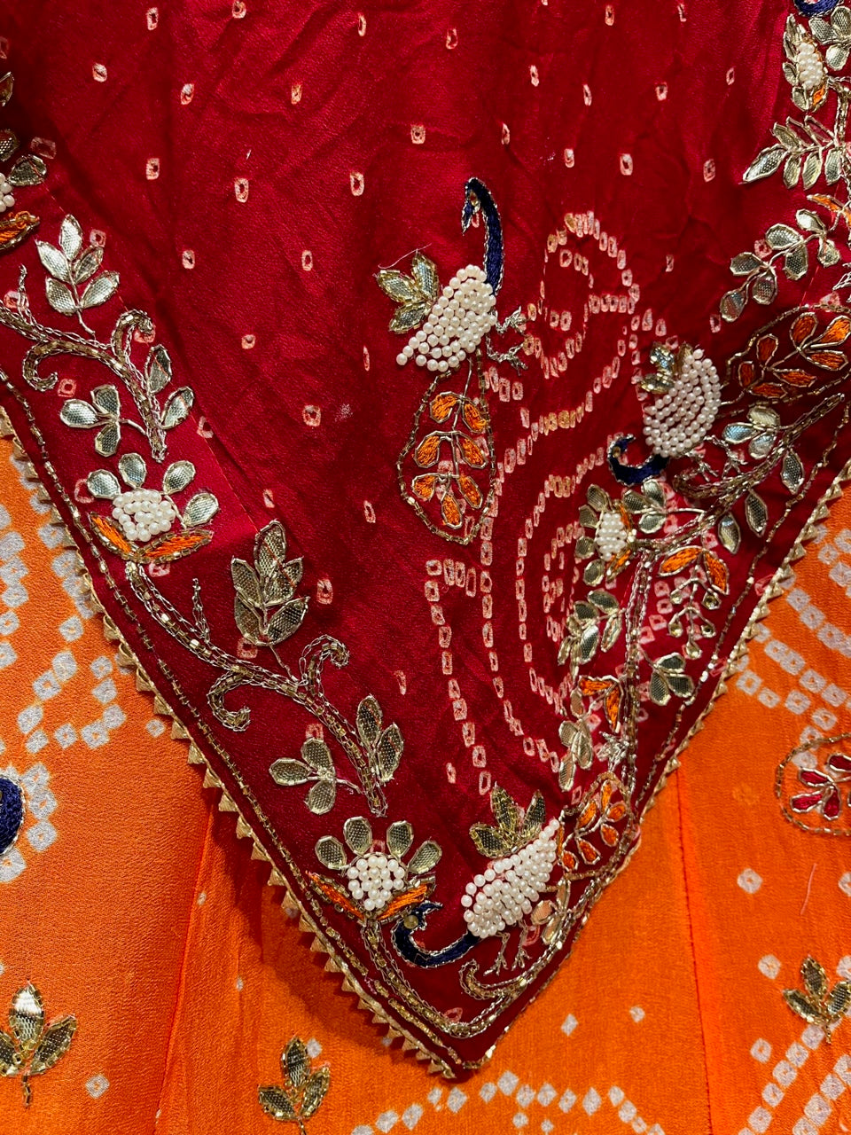 ( DELIVERY IN 25 DAYS ) ORANGE COLOUR PURE GEORGETTE OJARIYA BANDHEJ LEHENGA EMBELLISHED WITH GOTA PATTI & PEARL WORK
