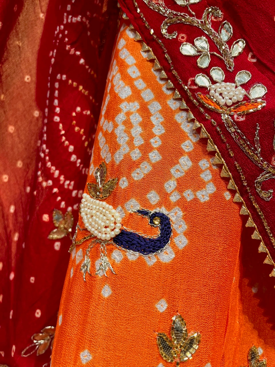 ( DELIVERY IN 25 DAYS ) ORANGE COLOUR PURE GEORGETTE OJARIYA BANDHEJ LEHENGA EMBELLISHED WITH GOTA PATTI & PEARL WORK