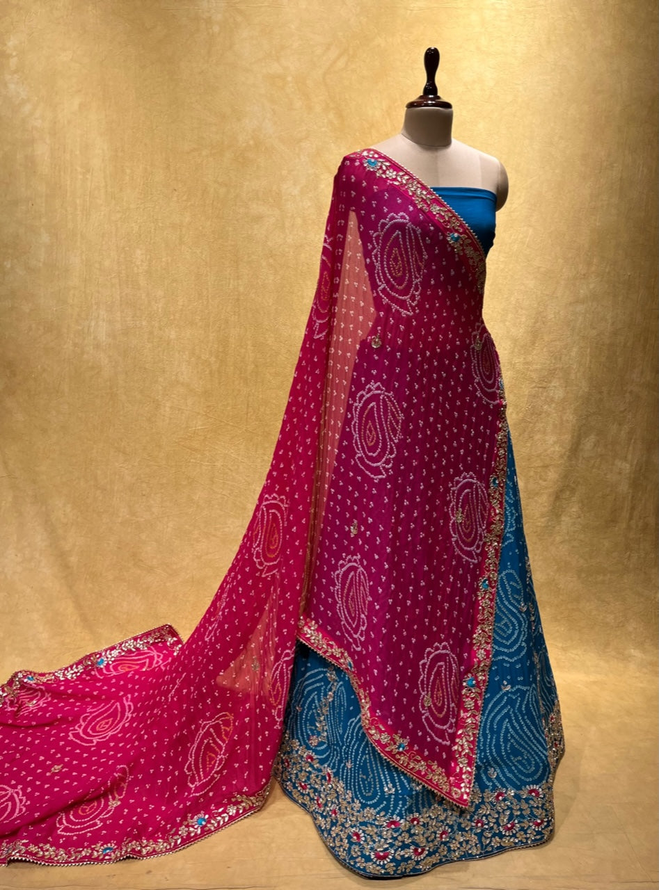 TURQUOISE COLOUR PURE GEORGETTE OJARIYA BANDHEJ LEHENGA EMBELLISHED WITH CUTDANA & GOTA PATTI WORK