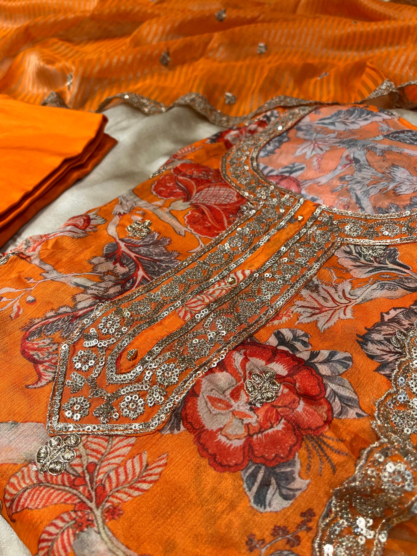 ORANGE COLOUR CHINON PRINTED UNSTITCHED SUIT WITH ORGANZA TISSUE DUPATTA EMBELLISHED WITH SEQUINS & ZARI WORK