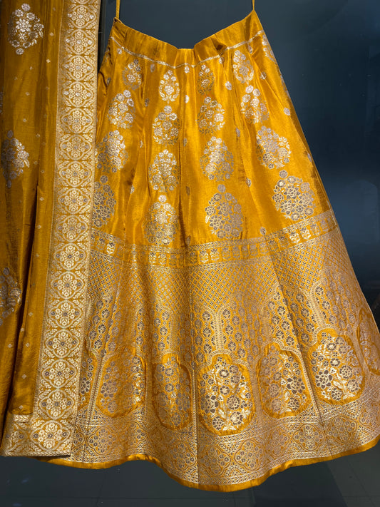 ( DELIVERY IN 25 DAYS ) MUSTARD COLOR BANARASI SILK LEHENGA WITH UNSTITCHED BLOUSE EMBELLISHED WITH ZARI WEAVES