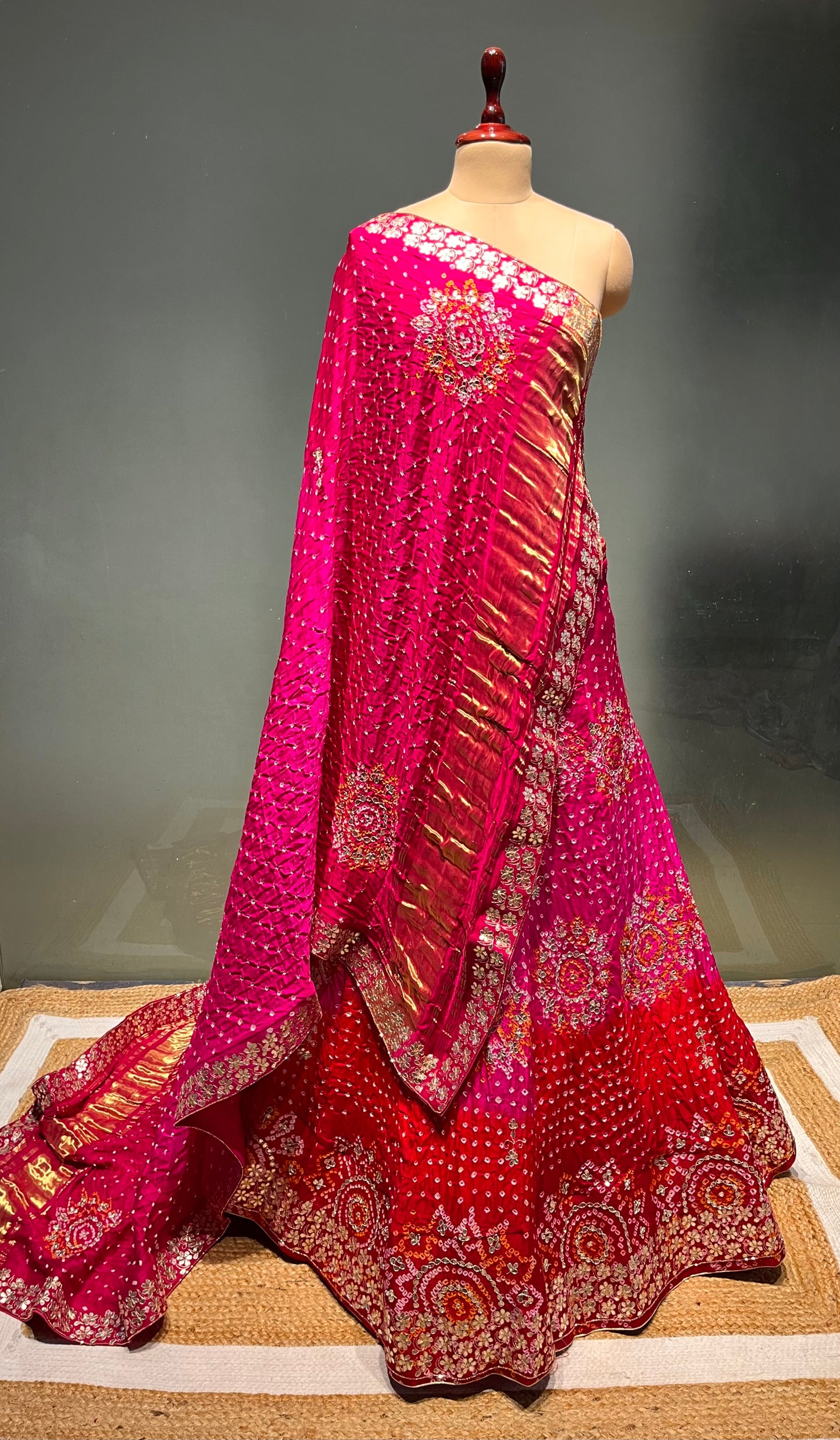 ( DELIVERY IN 15-20 DAYS ) PINK COLOUR SHADED PURE SATIN SILK BANDHEJ LEHENGA WITH UNSTITCHED BLOUSE EMBELLISHED WITH GOTA PATTI & ZARDOZI WORK