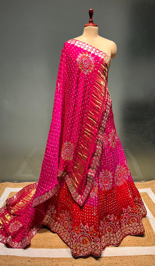 ( DELIVERY IN 15-20 DAYS ) PINK COLOUR SHADED PURE SATIN SILK BANDHEJ LEHENGA WITH UNSTITCHED BLOUSE EMBELLISHED WITH GOTA PATTI & ZARDOZI WORK