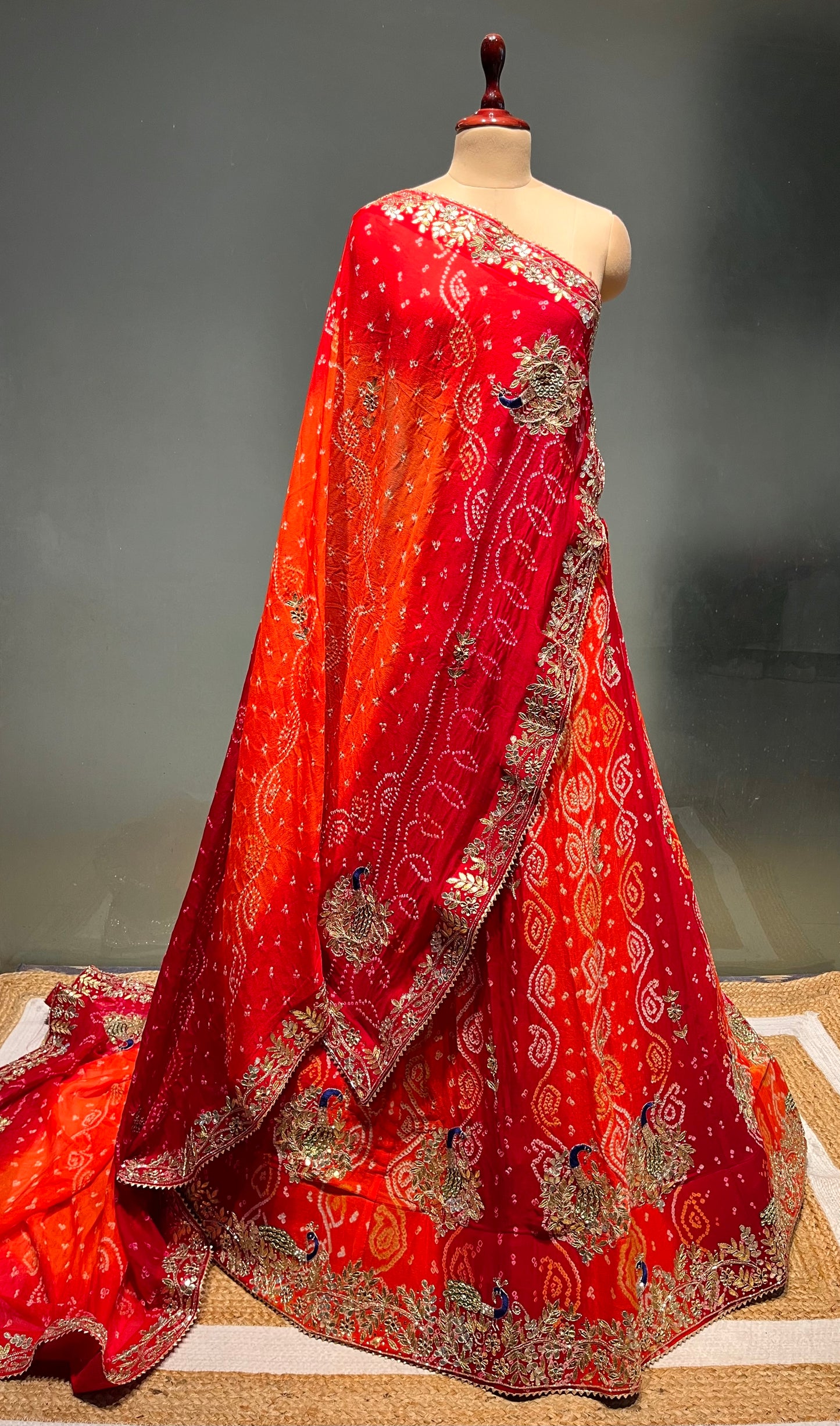 ORANGE & RED COLOUR PURE OJARIYA BANDHEJ LEHENGA WITH UNSTITCHED BLOUSE EMBELLISHED WITH GOTA PATTI, CUTDANA & ZARDOZI WORK