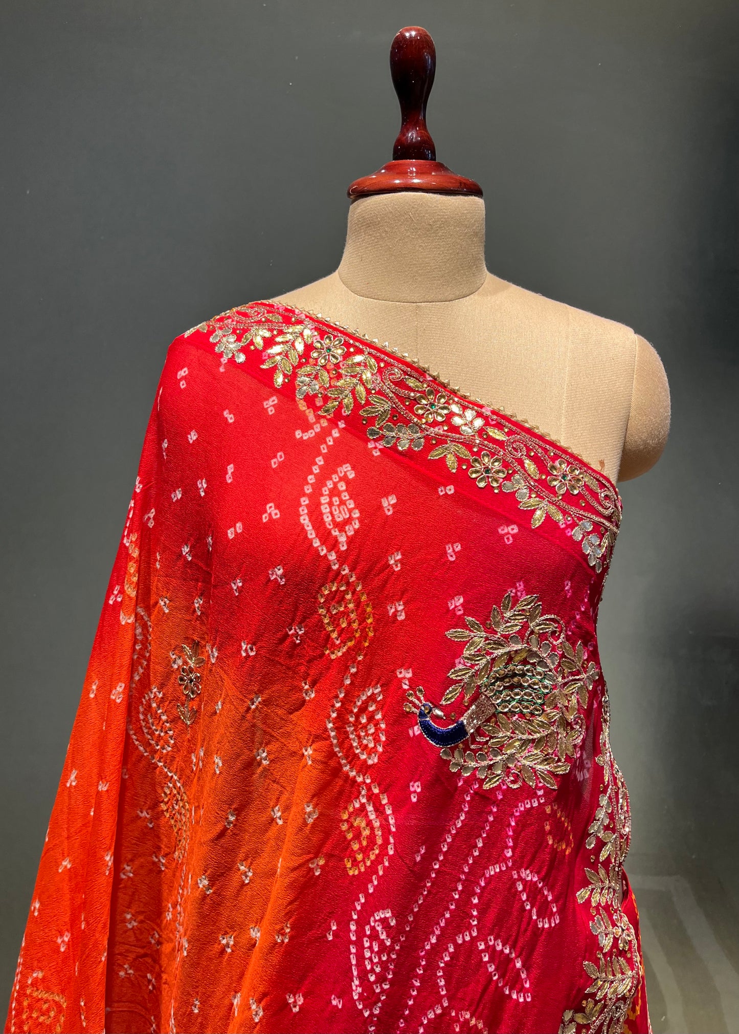 ORANGE & RED COLOUR PURE OJARIYA BANDHEJ LEHENGA WITH UNSTITCHED BLOUSE EMBELLISHED WITH GOTA PATTI, CUTDANA & ZARDOZI WORK