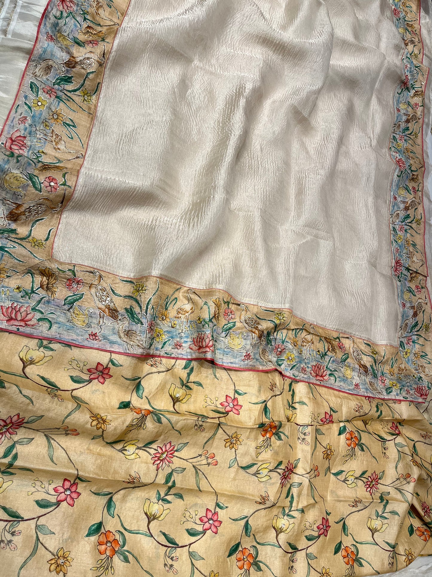 OFF WHITE COLOR CRUSHED TISSUE SAREE WITH TUSSAR SILK BLOUSE EMBELLISHED EITH AARI & BIRDS BORDER