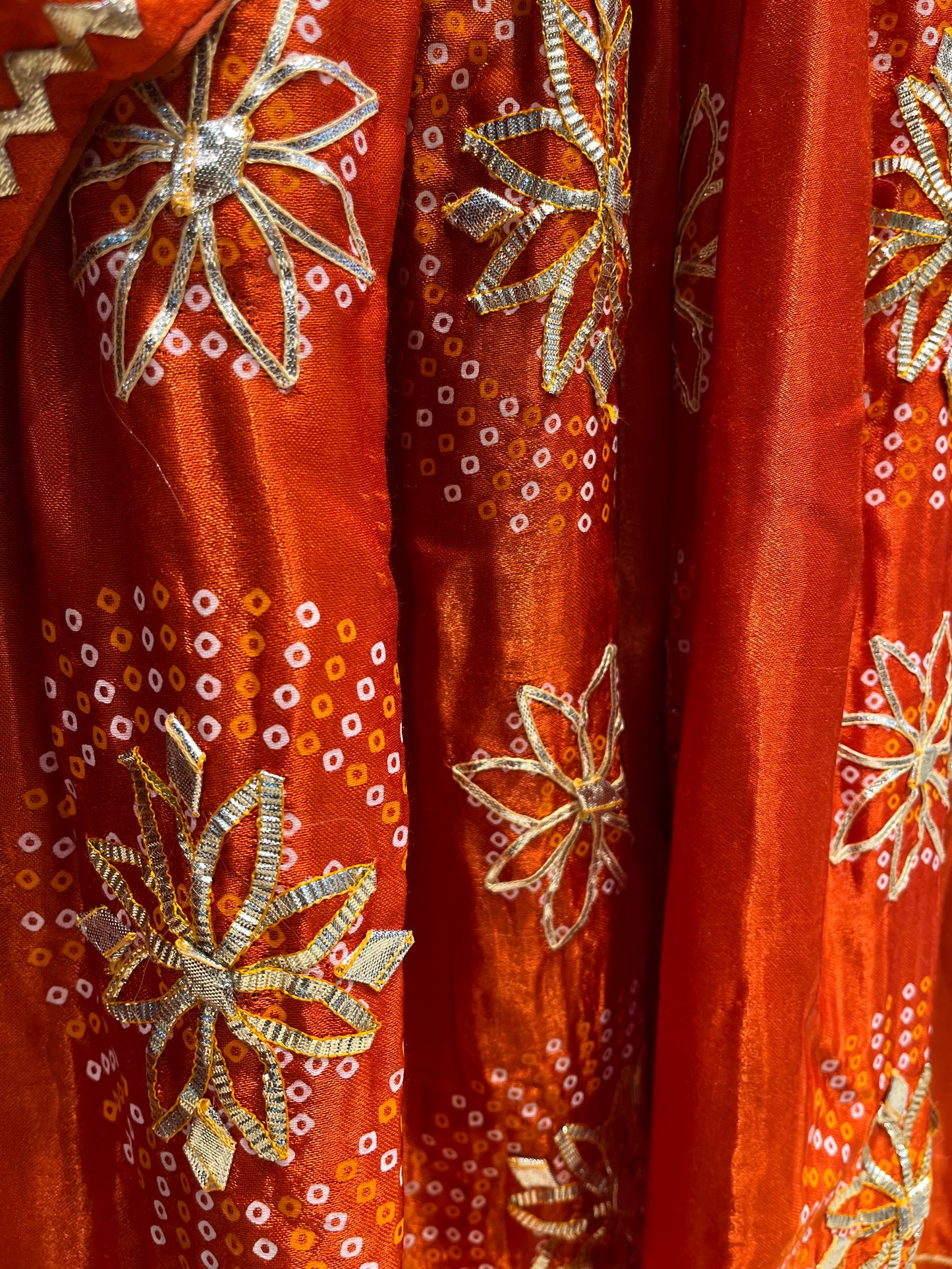 ORANGE COLOUR GAJJI SILK BANDHANI LEHENGA WITH UNSTITCHED BLOUSE EMBELLISHED WITH GOTA PATTI WORK - Kothari Sons