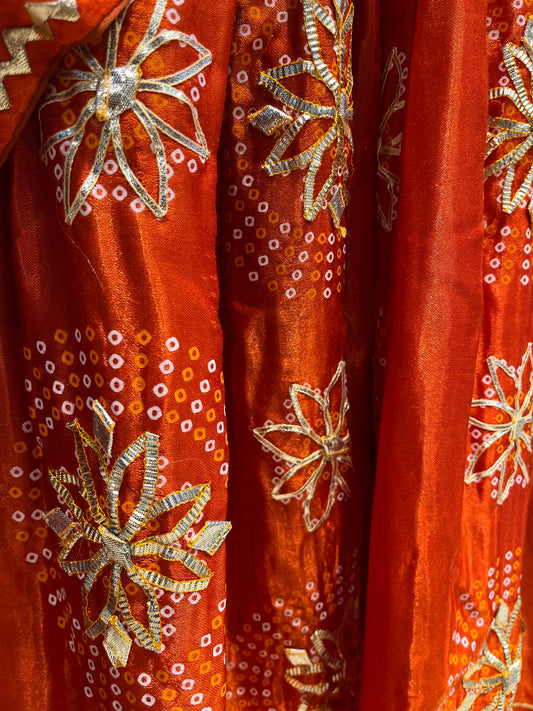 ORANGE COLOUR GAJJI SILK BANDHANI LEHENGA WITH UNSTITCHED BLOUSE EMBELLISHED WITH GOTA PATTI WORK