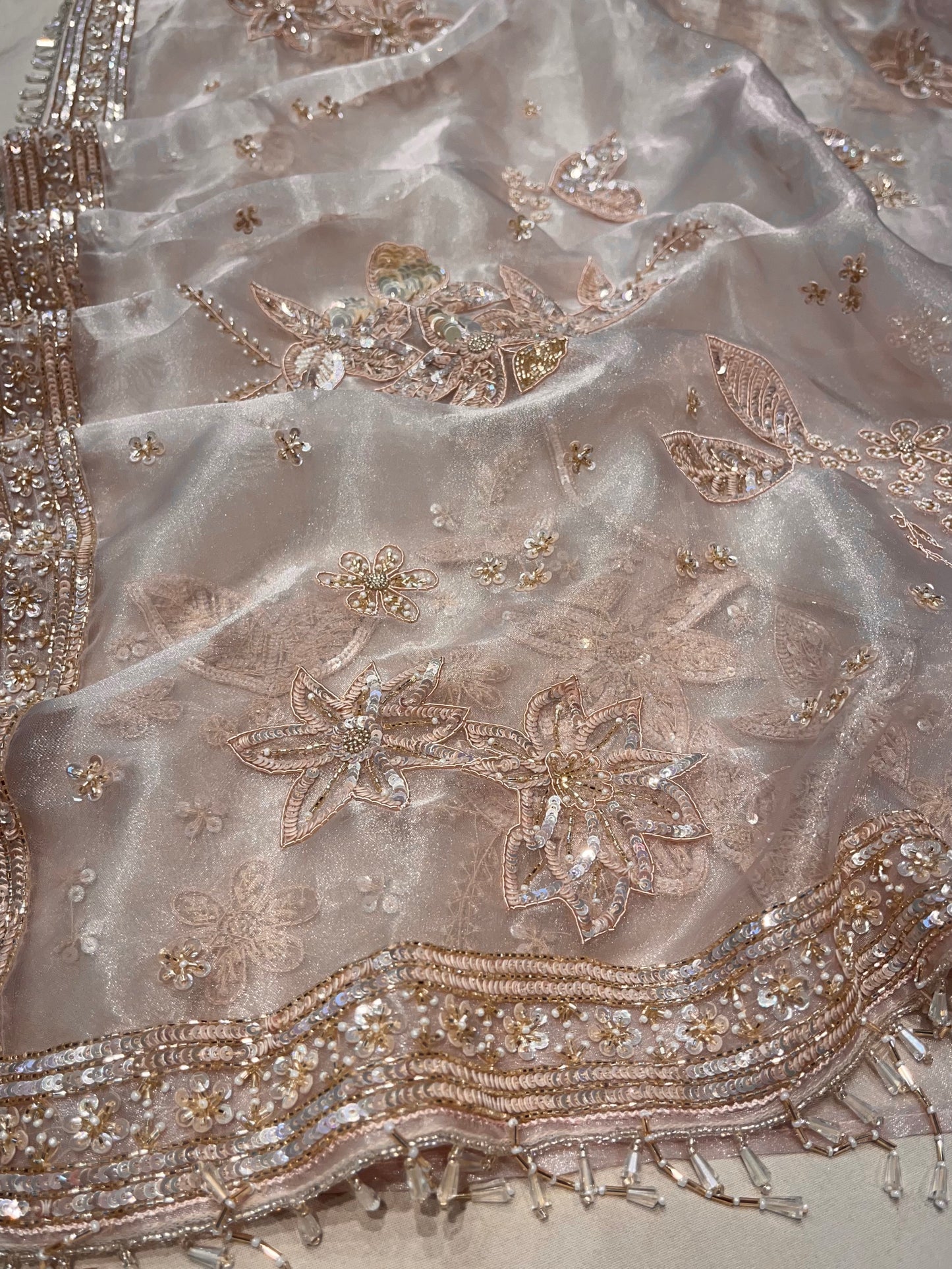 PASTEL PEACH COLOUR ORGANZA TISSUE HAND EMBROIDERED SAREE EMBELLISHED WITH CUTDANA, SEQUINS & ZARDOZI WORK