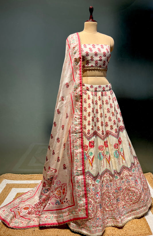 IVORY COLOUR PRINTED SILK LEHENGA WITH UNSTITCHED BLOUSE EMBELLISHED WITH CUTDANA & BEADS WORK