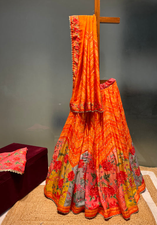 ORANGE COLOUR PRINTED SILK LEHENGA WITH UNSTITCHED BLOUSE EMBELLISHED WITH CUTDANA & SEQUINS WORK