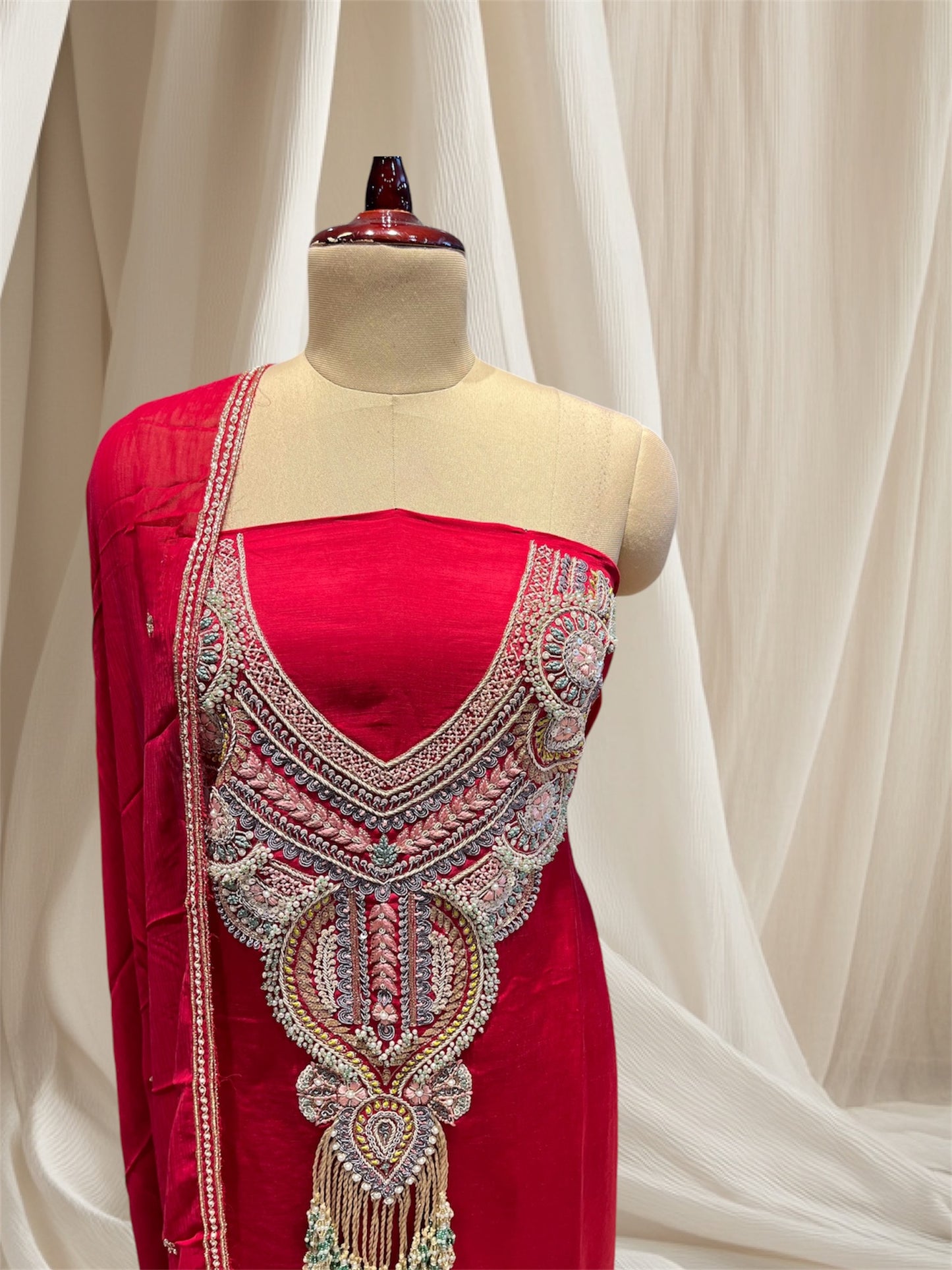 Red colour satin silk unstitched suit with zardozi / pearl / sequines / resham / embroidery and emerald tassels