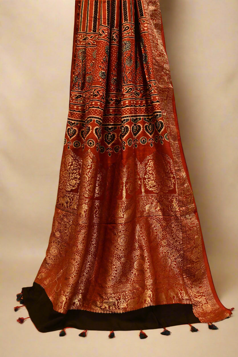 BLACK/RUST CONTRAST AJRAKH PRINT SAREE WITH RUST AJRAKH BLOUSE AND RICH BANARASI PALLA & BORDER IN PLANT-BASED SILK