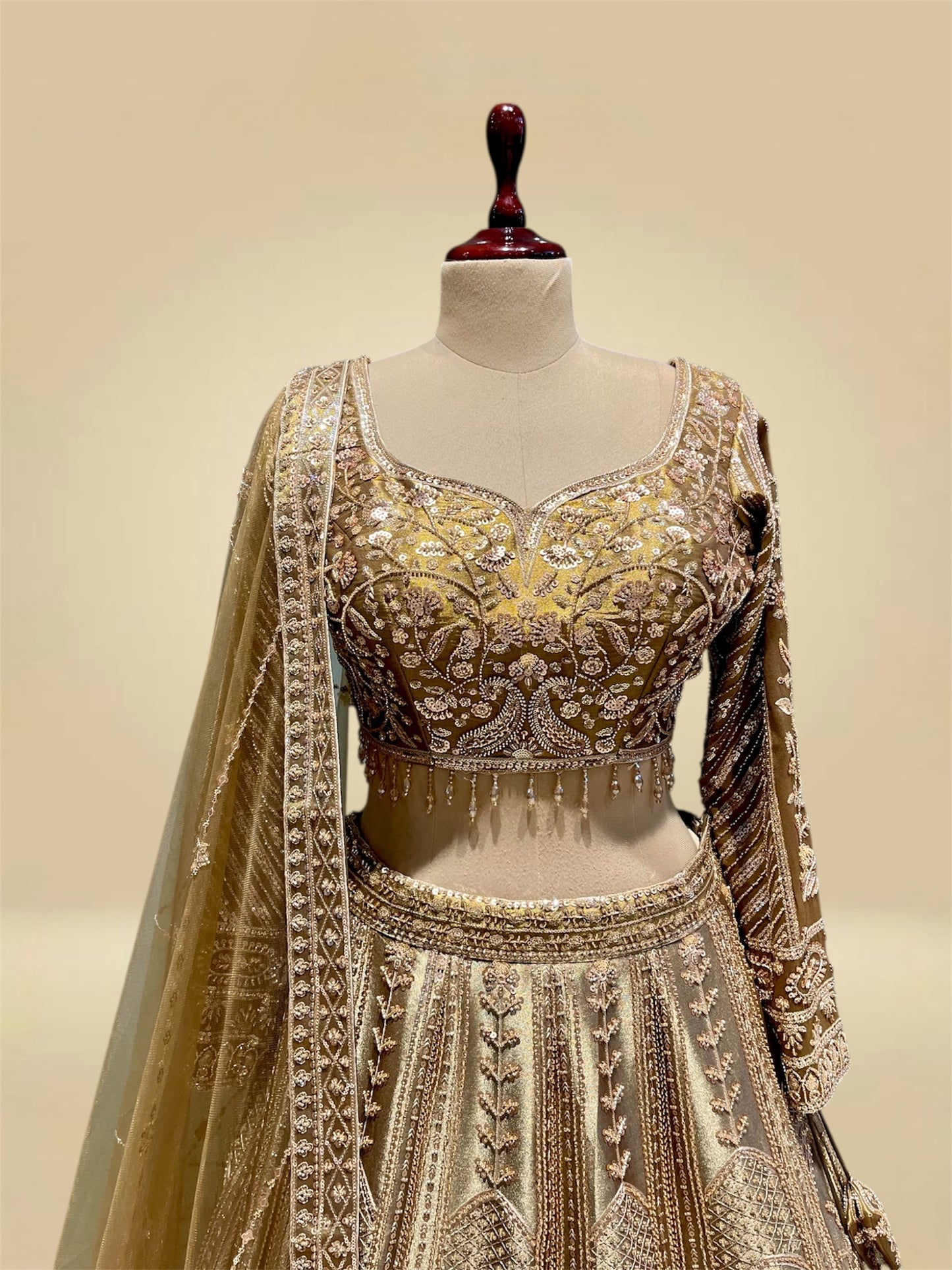 ANTIQUE GOLDEN TISSUE LEHENGA EMBELLISHED WITH SEQUINS, CUTDANA & RESHAM WORK