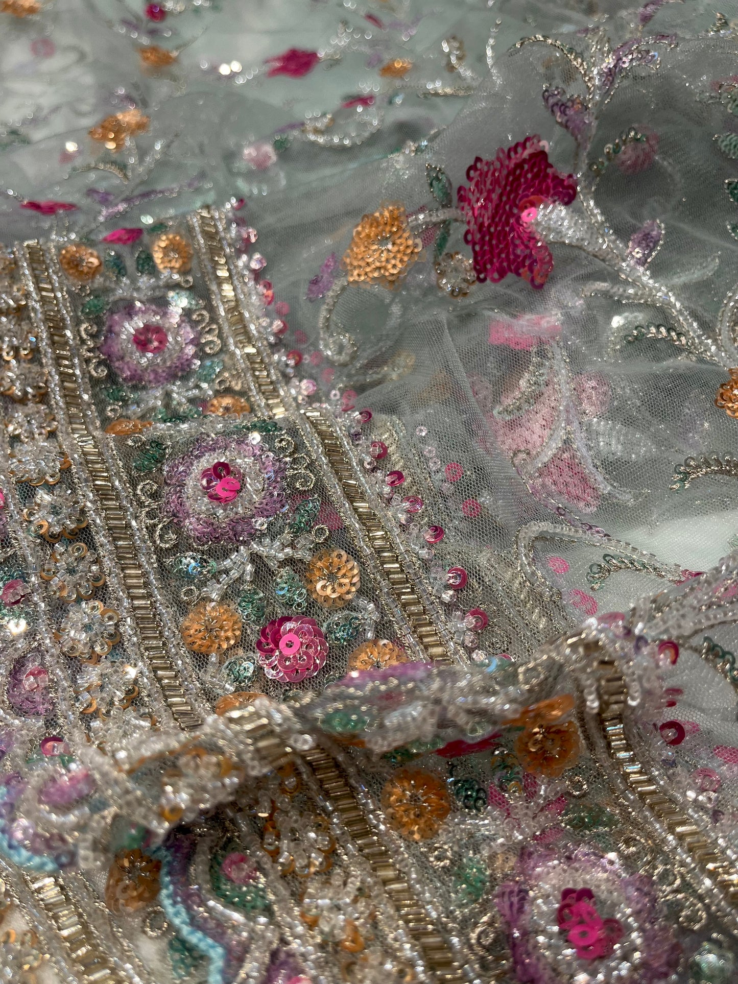 PASTEL BLUE NET SAREE  EMBELLISHED WITH SEQUINS & CUTDANA WORK PAIRED WITH A READYMADE BLOUSE