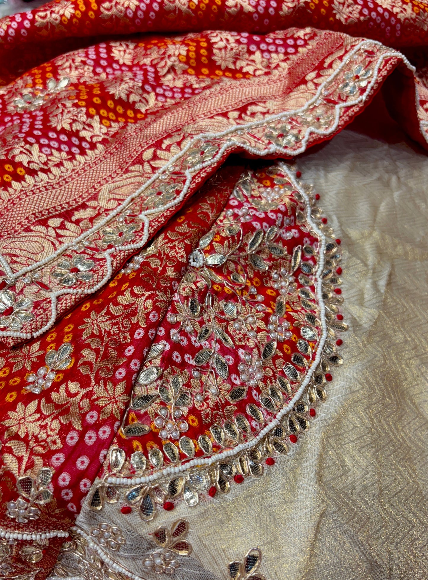 IVORY-RED COLOUR TISSUE GEORGETTE BANDHANI LEHENGA EMBELLISHED WITH GOTA PATTI & ZARDOZI WORK