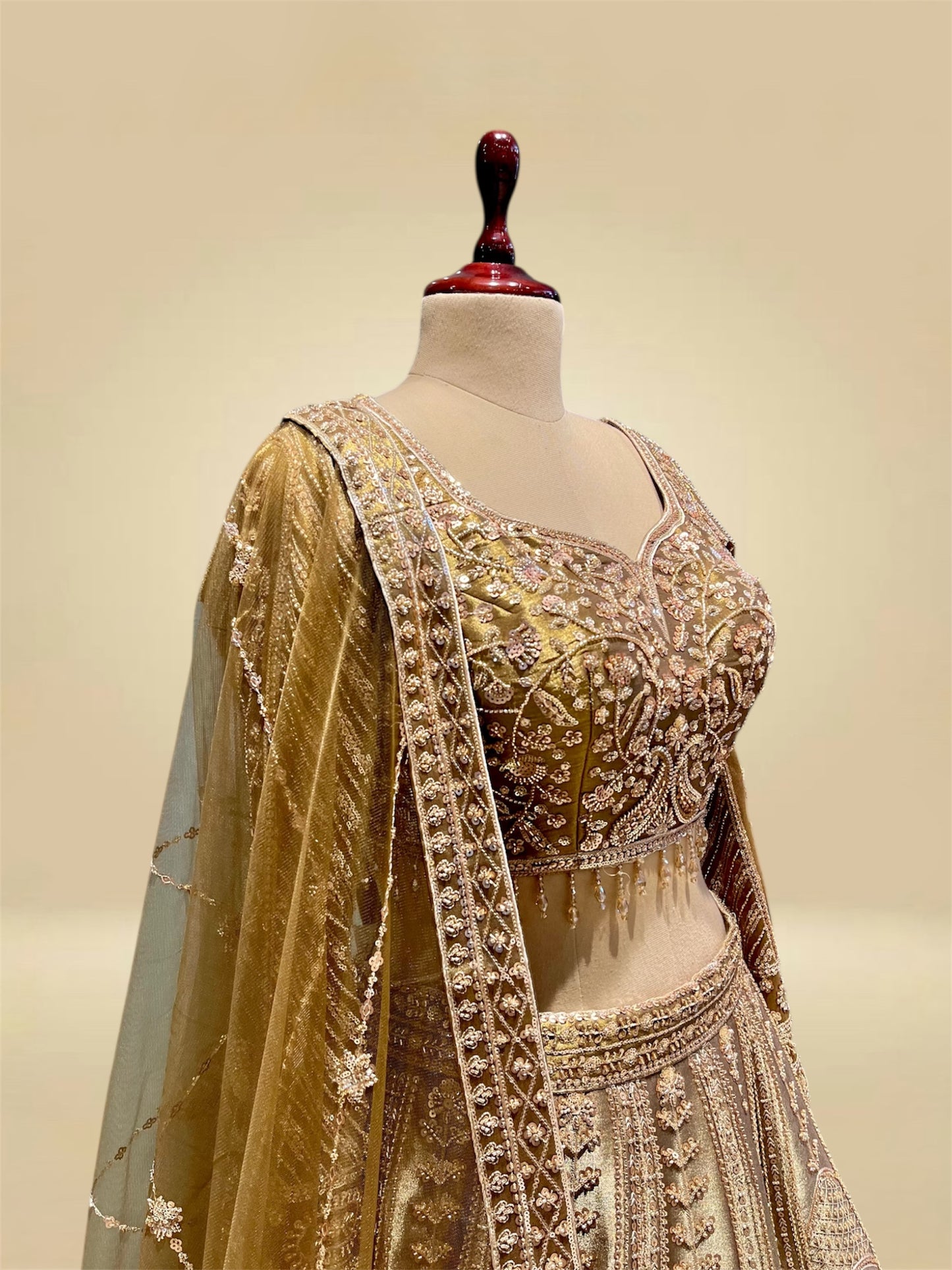 ANTIQUE GOLDEN TISSUE LEHENGA EMBELLISHED WITH SEQUINS, CUTDANA & RESHAM WORK