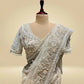 IVORY COLOUR NET SAREE EMBELLISHED WITH CUTDANA & SEQUINS, PAIRED WITH A READYMADE BLOUSE