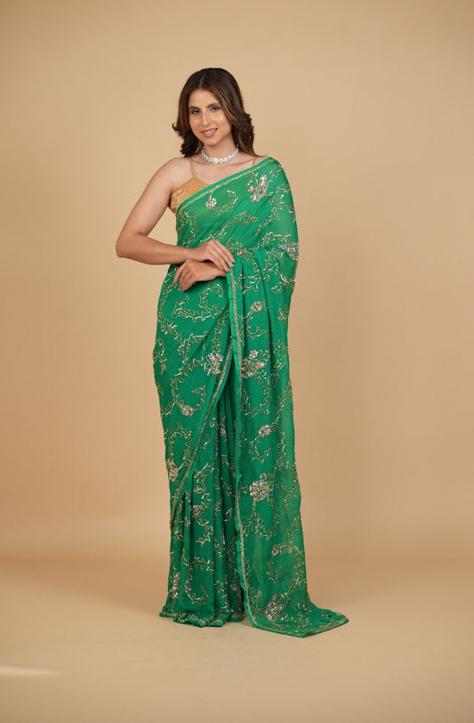EMERALD GREEN PURE PLATINUM CHIFFON SAREE WITH SEQUINS JAAL HAND EMBROIDERY PAIRED WITH CREPE BLOUSE WITH EMBROIDERED SLEEVES