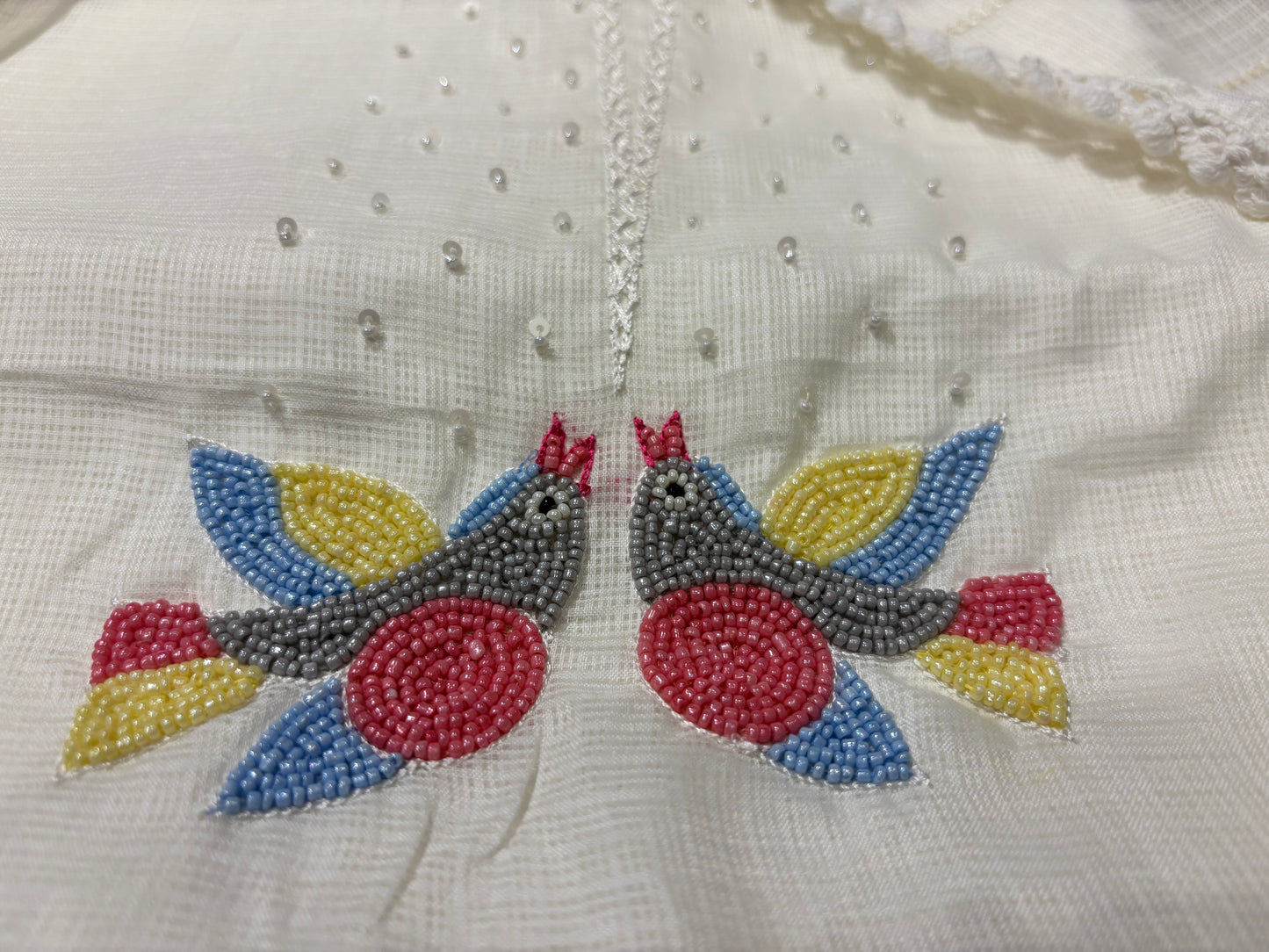 OFF WHITE KOTA DORIYA UNSTITCHED SUIT WITH RESHAM EMBROIDERED BIRD MOTIFS DUPATTA AND BEAD WORK KURTA