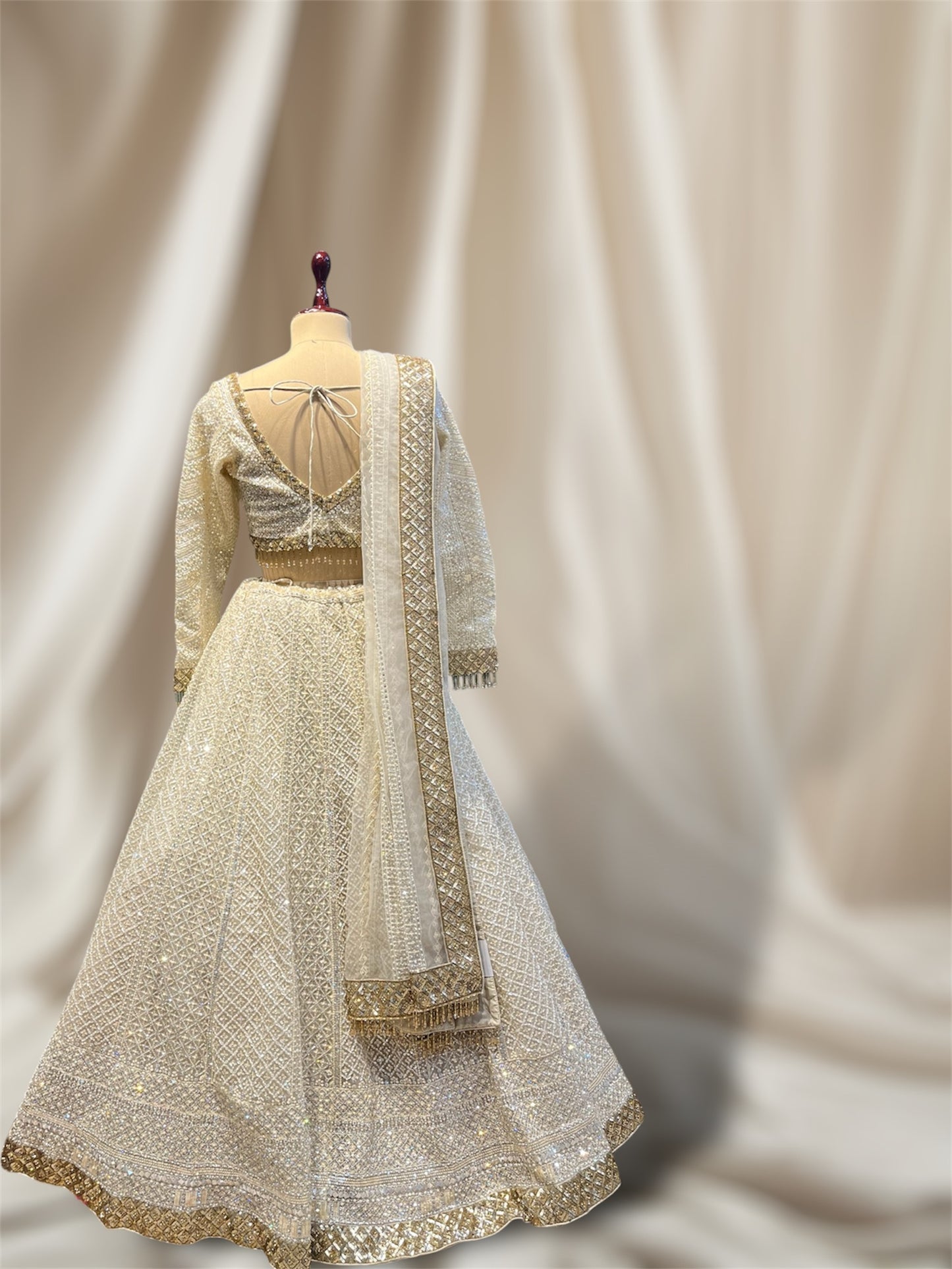 IVORY COLOUR NET HAND EMBROIDERD CROP TOP LEHENGA EMBELLISHED WITH CUTDANA & SEQUINES WORK