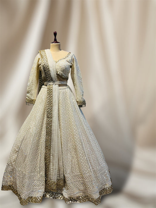 IVORY COLOUR NET HAND EMBROIDERD CROP TOP LEHENGA EMBELLISHED WITH CUTDANA & SEQUINES WORK