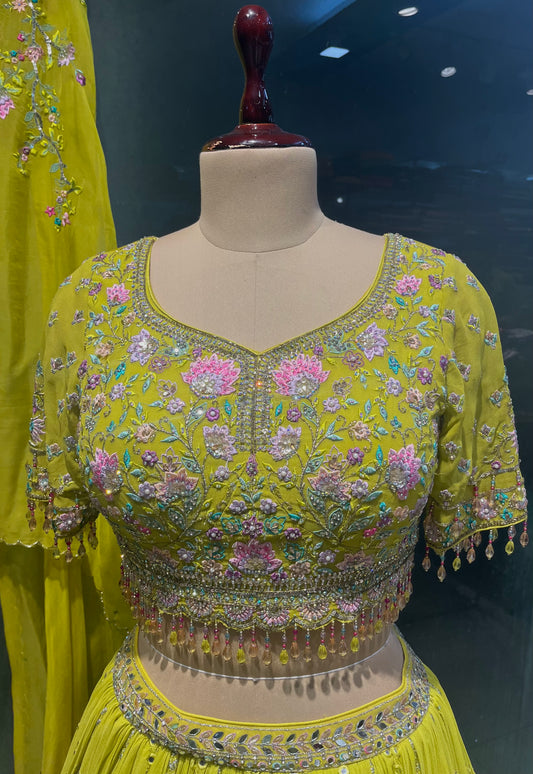 MIRROR WORK GEORGETTE LEHENGA PAIRED WITH MULTICOLOUR RESHAM EMBROIDERED CROP TOP AND ORGANZA SHRUG