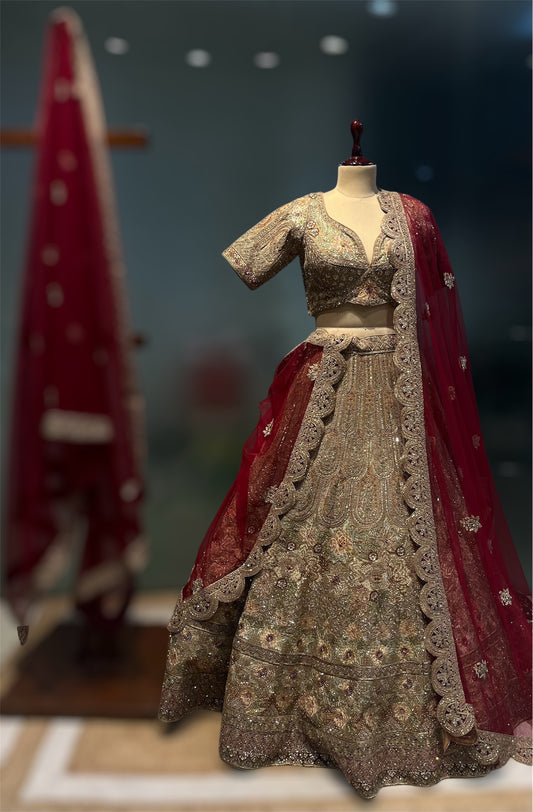 GOLDEN MATTE FINISH ZARI LEHENGA WITH READY MADE BLOUSE AN RED CONTRAST SCULPING BOARDER DUPATTA PAIRED WITH ONE EXTRA RED DUPATTA