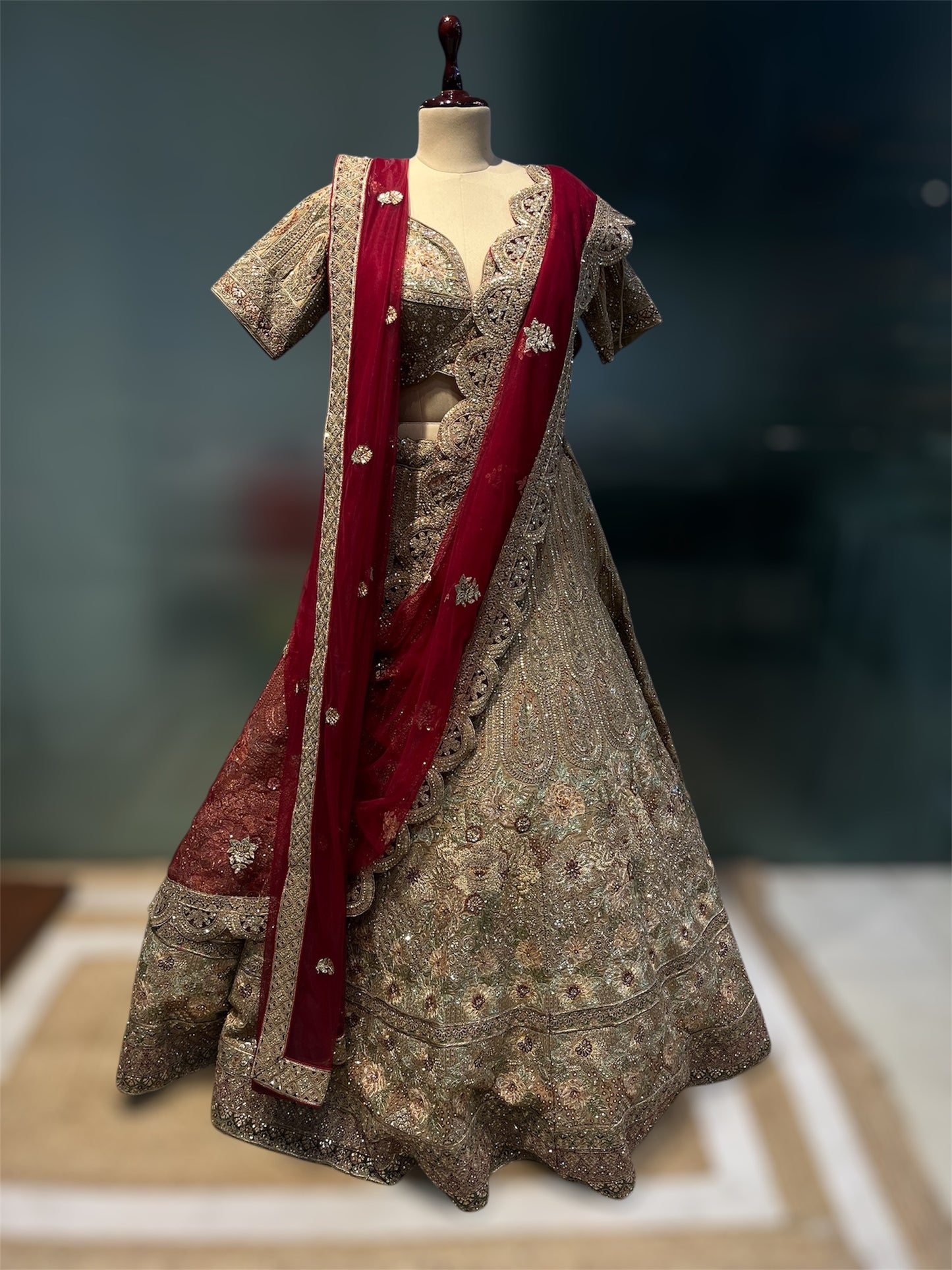 GOLDEN MATTE FINISH ZARI LEHENGA WITH READY MADE BLOUSE AN RED CONTRAST SCULPING BOARDER DUPATTA PAIRED WITH ONE EXTRA RED DUPATTA