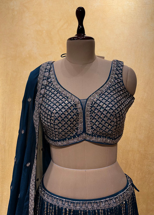( DELIVERY IN 25 DAYS ) TEAL BLUE COLOR CHINON LEHENGA WITH READYMADE CROP TOP BLOUSE EMBELLISHED WITH ZARI & CUTDANA WORK