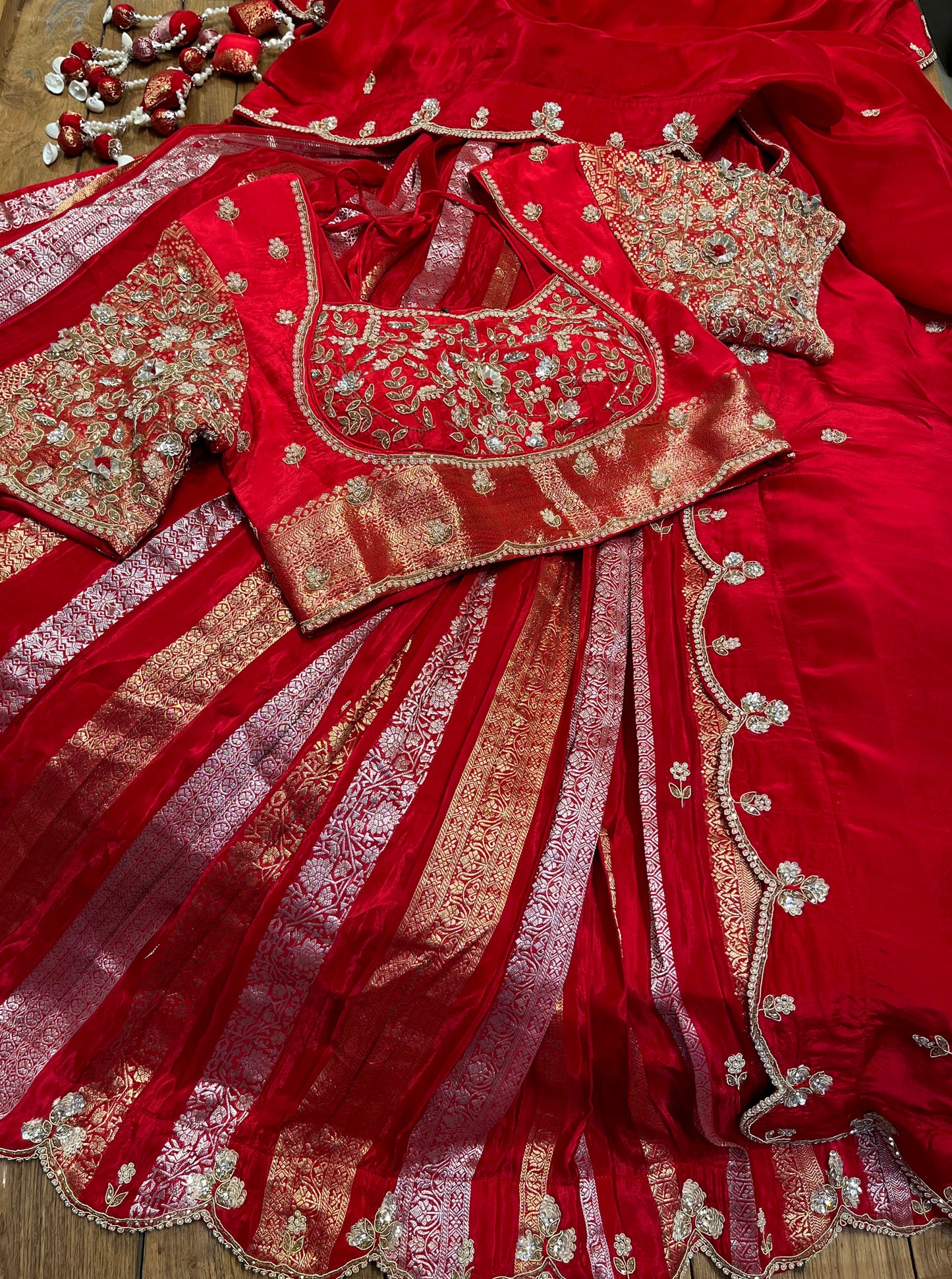 RED COLOUR CREPE SILK ZARI STRIPES LEHENGA WITH EMBROIDERED BLOUSE & SCALLOP DUPATTA EMBELLISHED WITH ZARDOZI, PEARL & CUTDANA WORK