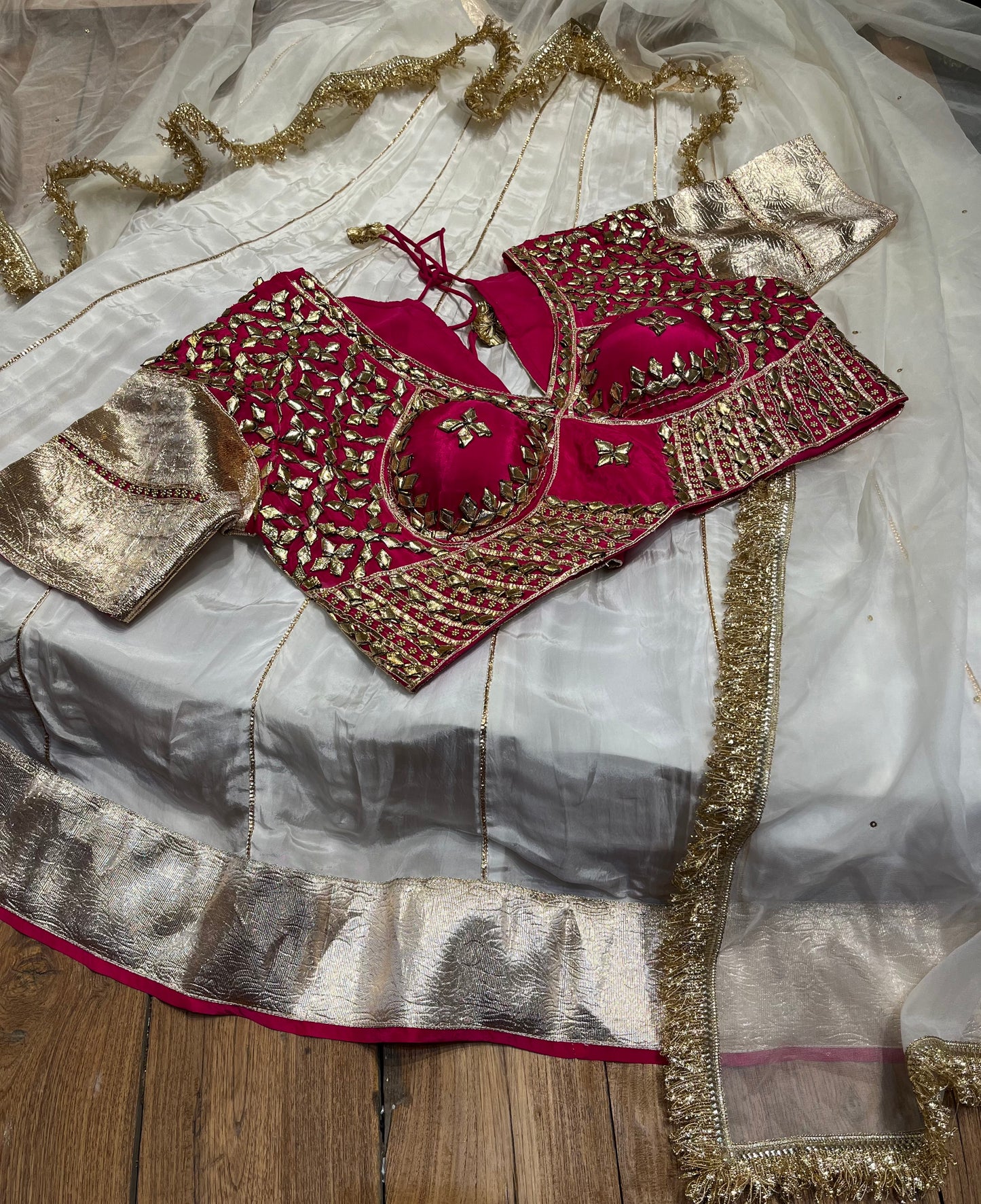 WHITE COLOUR CREPE SILK LEHENGA WITH CONTRAST READYMADE BLOUSE & ORGANZA DUPATTA EMBELLISHED WITH GOTA PATTI WORK