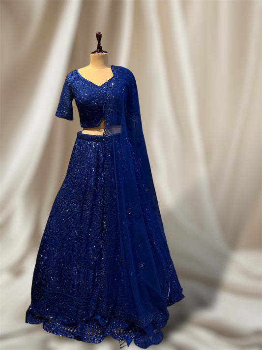 NAVY BLUE COLOUR NET SEQUINES EMBROIDERED LEHENGA WITH CROP TOP & SCULPING BOARDER DUPATTA EMBELLISHED WITH SEQUINES WORK